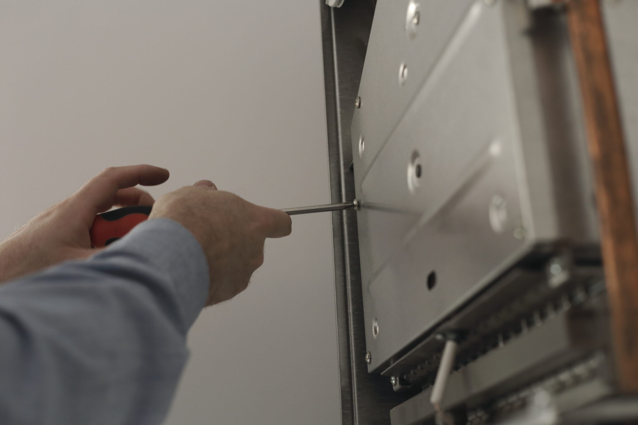 close-up-cropped-hand-repairing-electronic-equipment-home