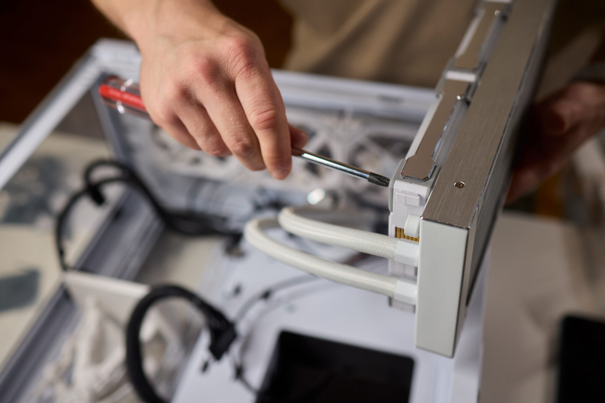 A detailed closeup view of a person carefully installing a CPU cooler within a sleek, modern computer case